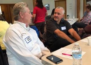 Scott Colton, Corporate CFO, and Dean Hendrix, IRM Director, chat during a break.